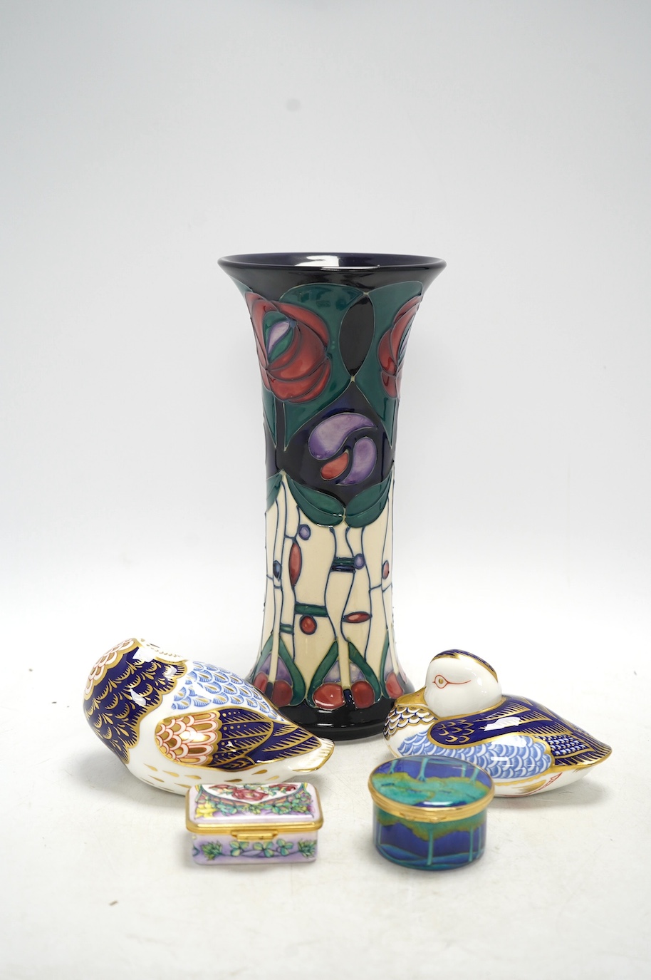 A Moorcroft vase, two Moorcroft design enamel boxes and two Crown Derby birds, vase 25cm. Condition - good